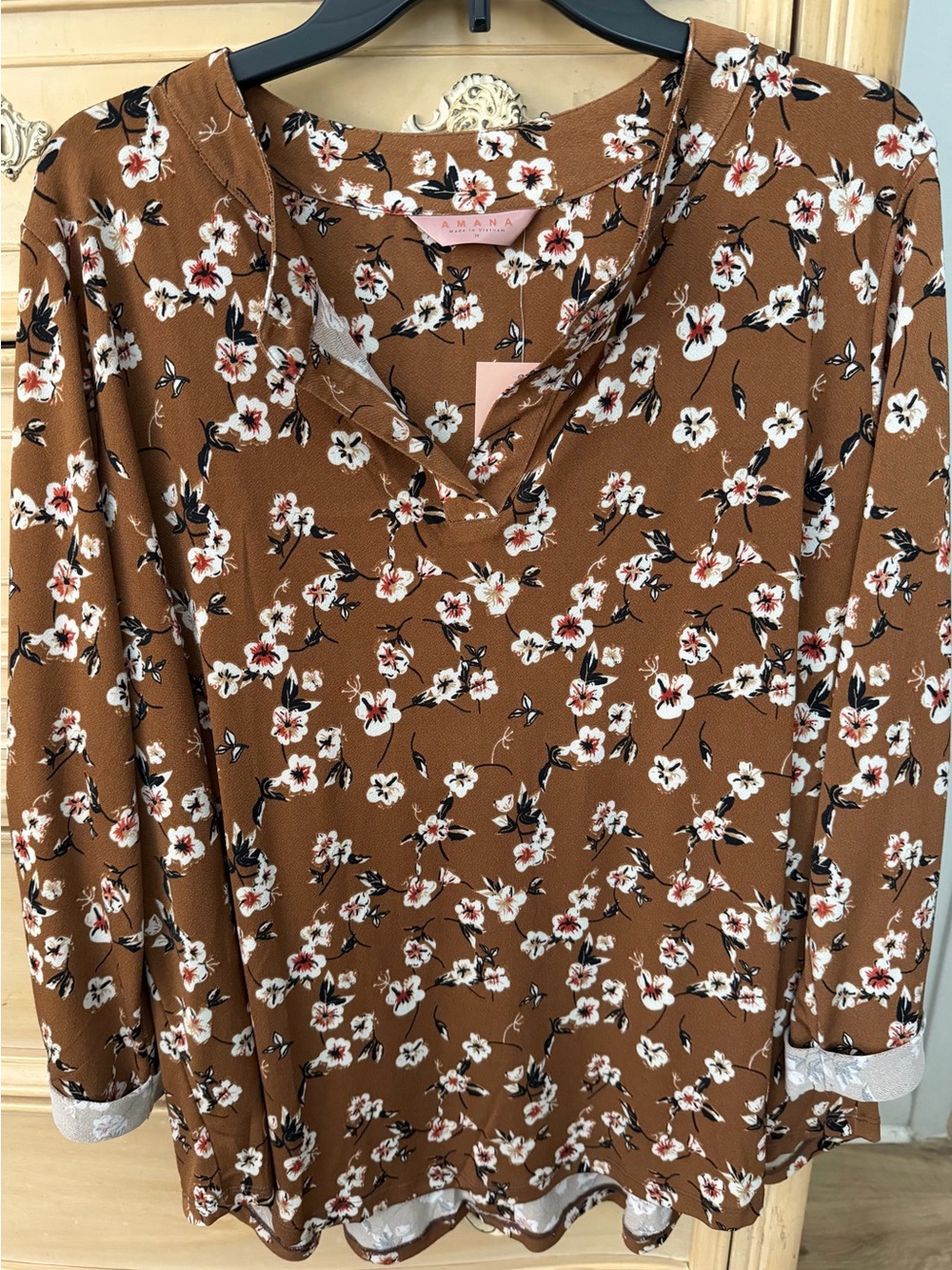 Amana women's brown floral blouse features a split neckline and 3/4 sleeves.